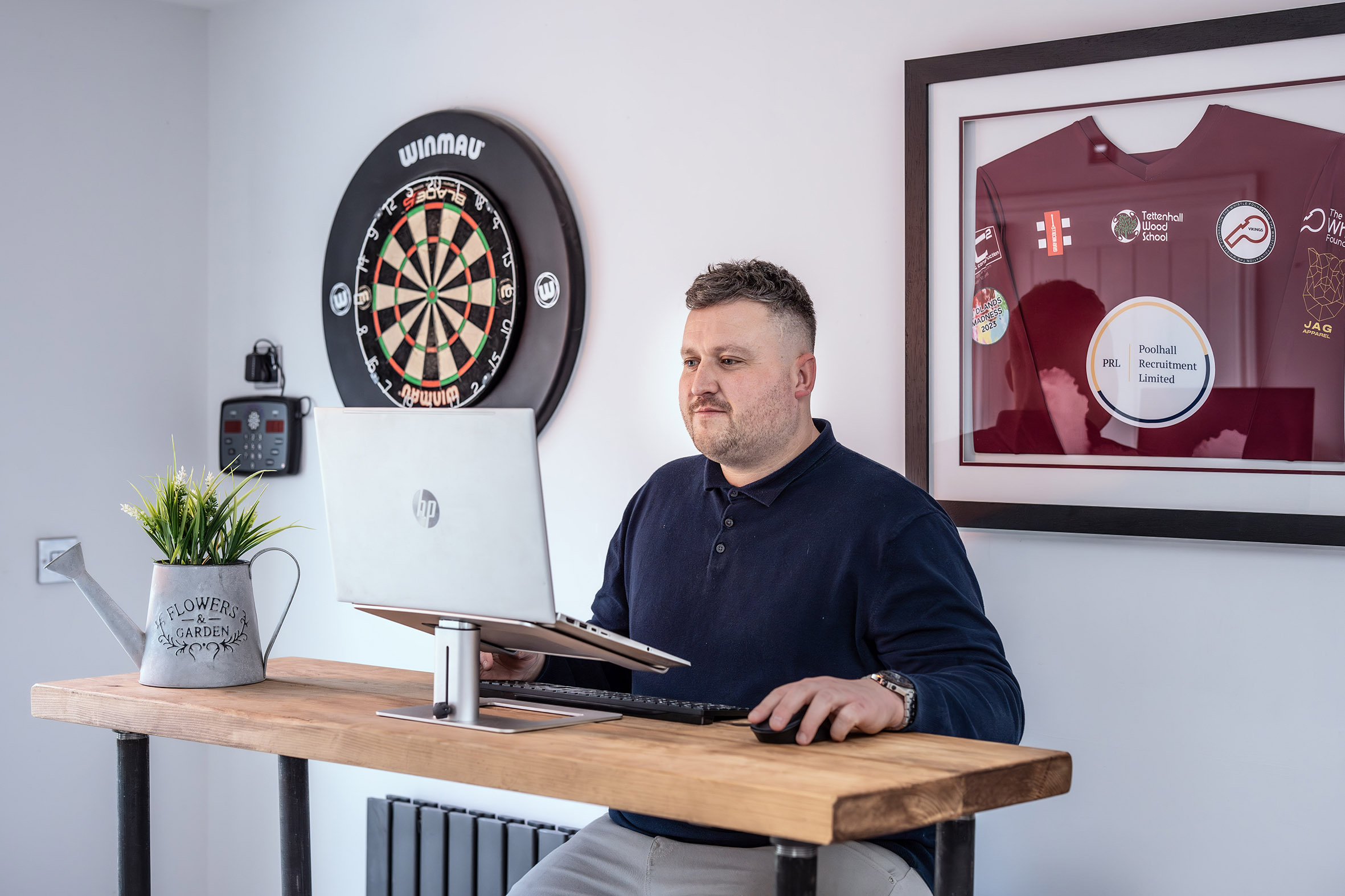The Poolhall office, dartboard and sponsored shirt on the wall