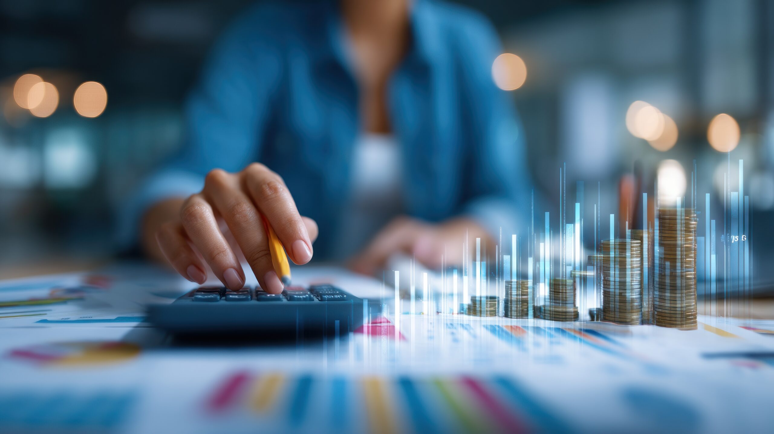 Finance professional working through figures with a calculator