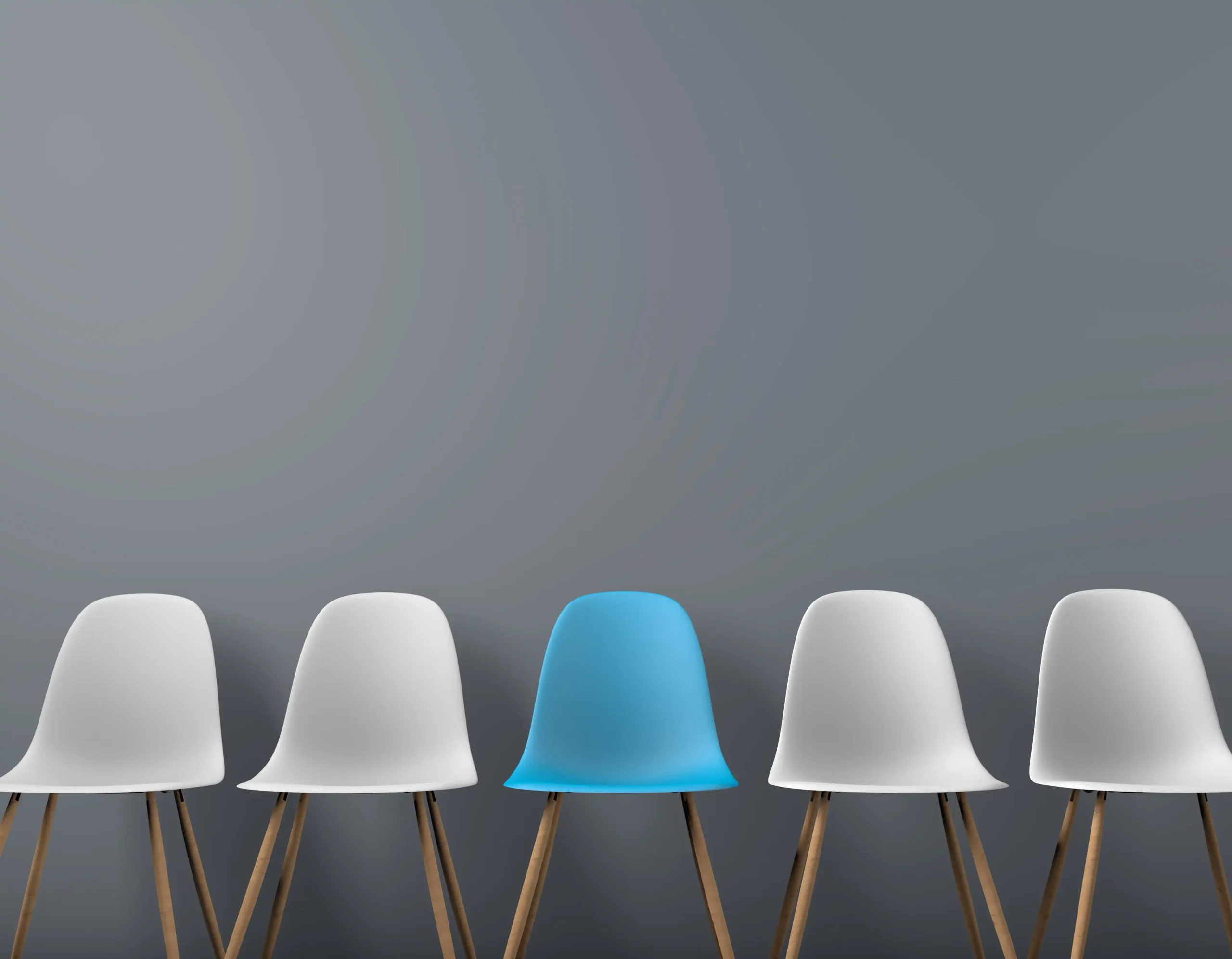 Row of white chairs with one blue chair standing out